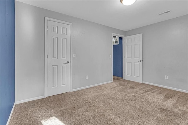 unfurnished bedroom featuring visible vents, baseboards, and carpet flooring