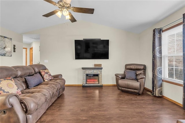 living room with lofted ceiling, a fireplace, baseboards, and wood finished floors