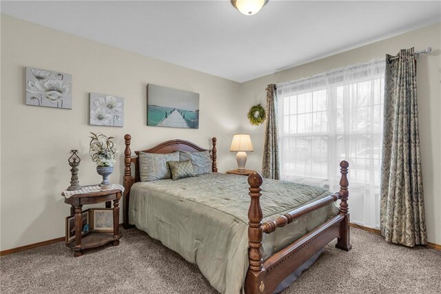 bedroom with carpet floors and baseboards