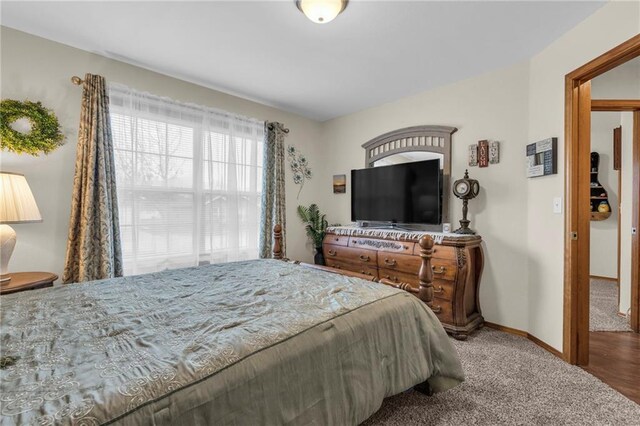 carpeted bedroom with baseboards