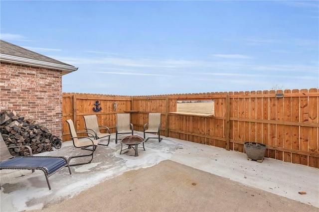 view of patio / terrace featuring a fire pit and fence