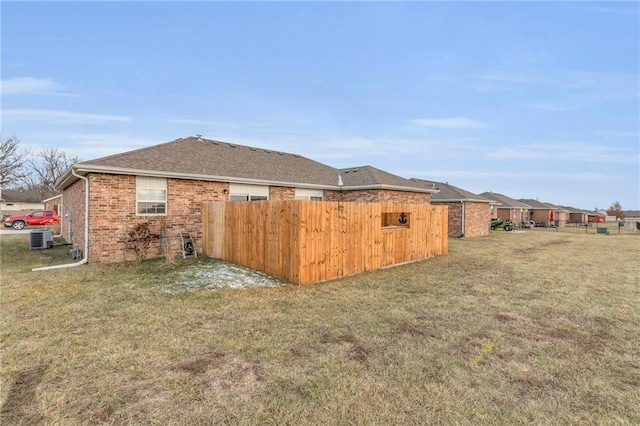 view of yard with fence and central air condition unit