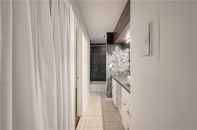 interior space featuring shower / bathtub combination with curtain, tile patterned flooring, electric panel, and vanity