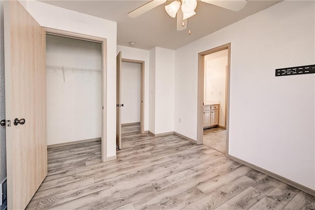 unfurnished bedroom with baseboards, light wood-type flooring, a closet, and ceiling fan