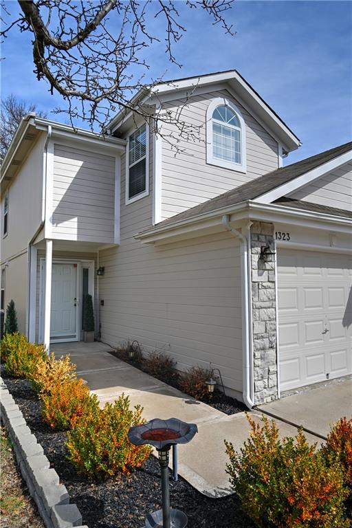 view of front facade featuring stone siding and a garage