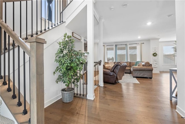 living area featuring recessed lighting, baseboards, and wood finished floors