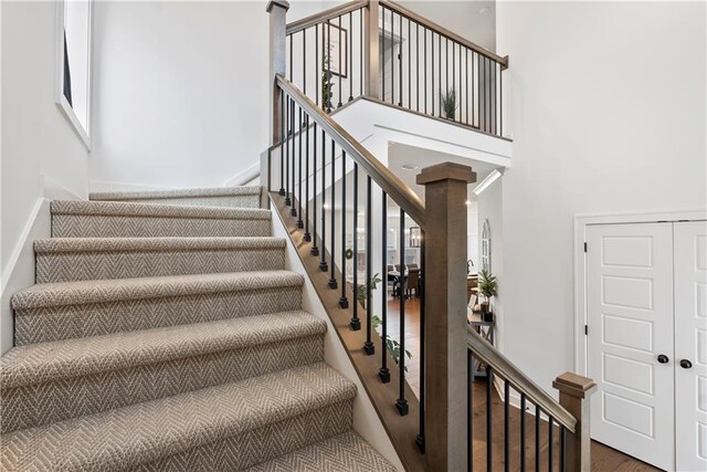 stairway featuring a high ceiling