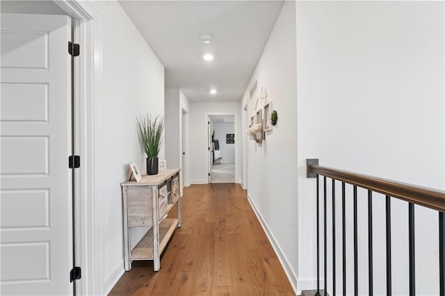 hall with recessed lighting, wood finished floors, and baseboards