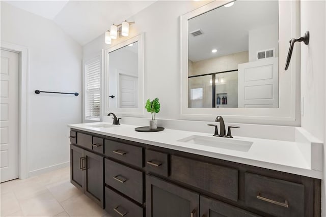 bathroom featuring a sink, visible vents, double vanity, and a shower stall