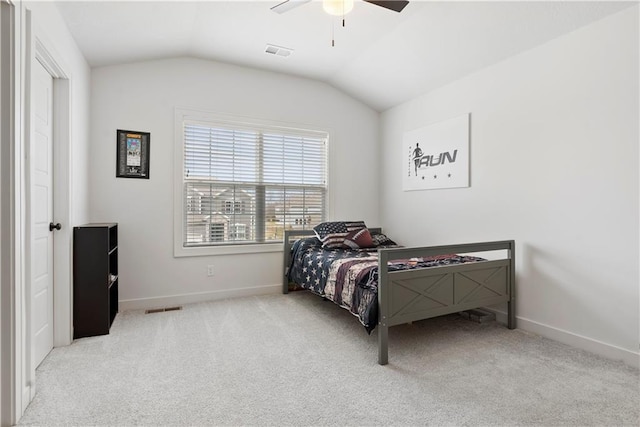 carpeted bedroom with visible vents, lofted ceiling, and baseboards