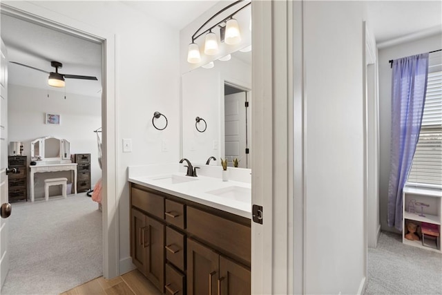 full bathroom with double vanity, connected bathroom, a ceiling fan, and a sink