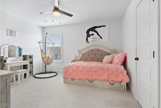 carpeted bedroom with a ceiling fan, visible vents, and baseboards