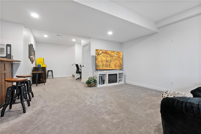 carpeted living room with recessed lighting, baseboards, and a bar