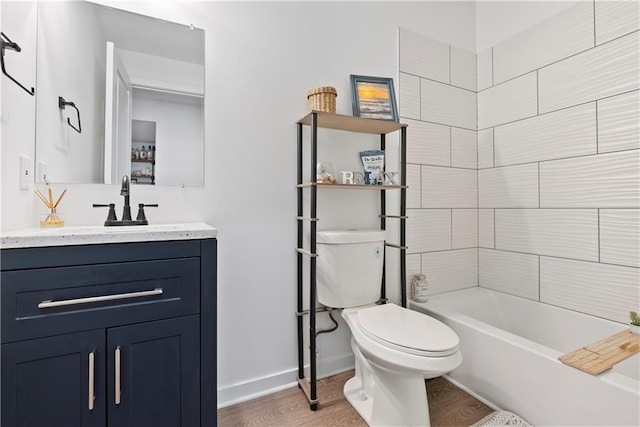 full bath featuring vanity, toilet, wood finished floors, and baseboards