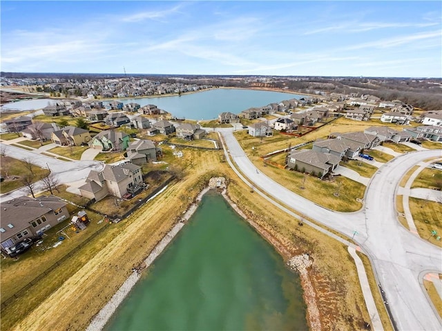 drone / aerial view with a residential view and a water view