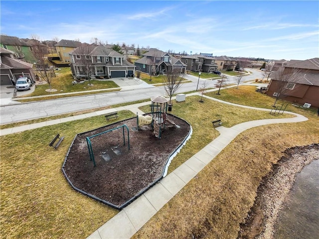 view of home's community featuring a residential view, playground community, and a yard