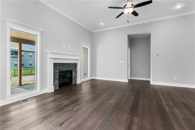 unfurnished living room with a fireplace, dark wood finished floors, visible vents, and baseboards