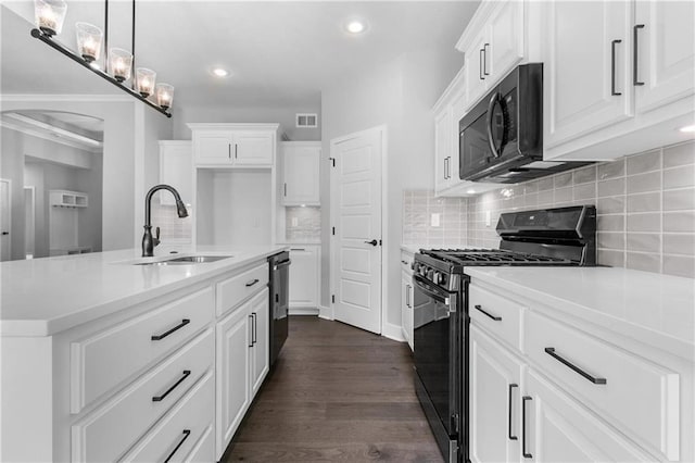 kitchen featuring a sink, visible vents, white cabinets, black appliances, and dark wood finished floors