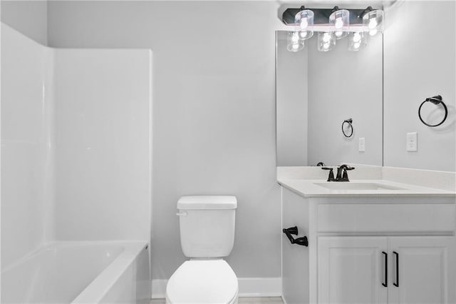 bathroom with washtub / shower combination, vanity, toilet, and baseboards