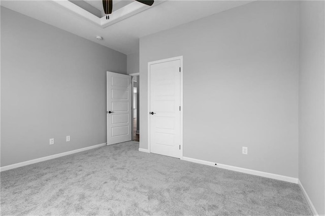 unfurnished bedroom with ceiling fan, carpet flooring, and baseboards