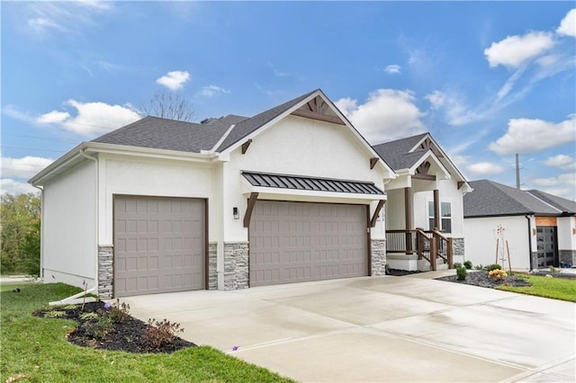 view of front facade featuring metal roof, a garage, stone siding, driveway, and a standing seam roof