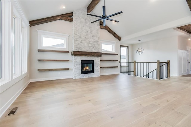 unfurnished living room featuring high vaulted ceiling, wood finished floors, visible vents, baseboards, and beamed ceiling