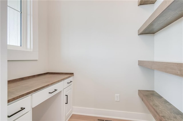 interior space featuring baseboards