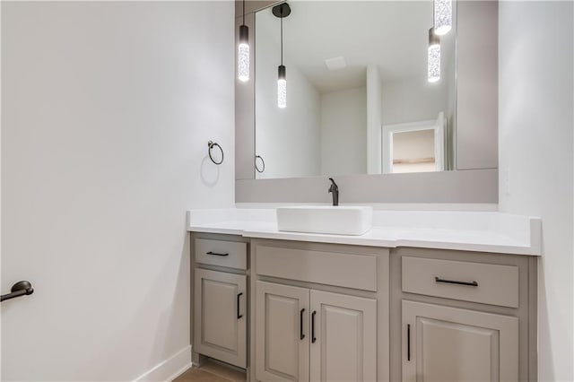 bathroom with baseboards and vanity