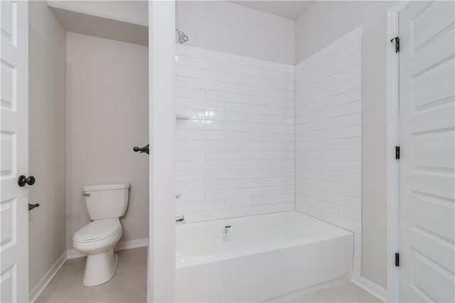 bathroom with baseboards, shower / bathing tub combination, toilet, and tile patterned floors