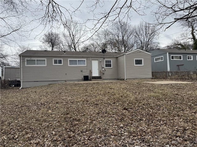10904 Cambridge Ave, Kansas City, MO 64134 - rear view of property with entry steps, central AC, and fence