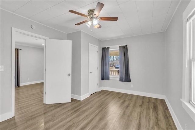 empty room with baseboards and wood finished floors