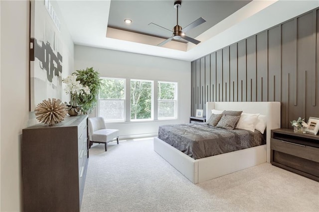12435 NW Arbor Way, Platte City, MO 64079 - carpeted bedroom with a tray ceiling, a ceiling fan, and recessed lighting