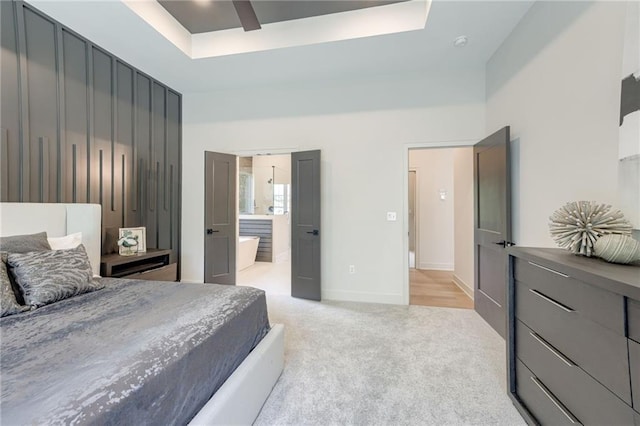 12435 NW Arbor Way, Platte City, MO 64079 - bedroom with a raised ceiling, light colored carpet, ensuite bathroom, and ceiling fan