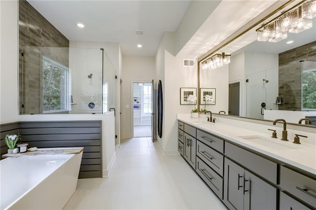 12435 NW Arbor Way, Platte City, MO 64079 - bathroom with double vanity, a stall shower, a freestanding bath, plenty of natural light, and recessed lighting