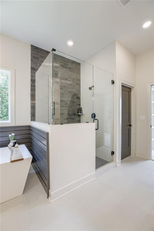 12435 NW Arbor Way, Platte City, MO 64079 - full bath with a stall shower, tile patterned flooring, recessed lighting, and a soaking tub