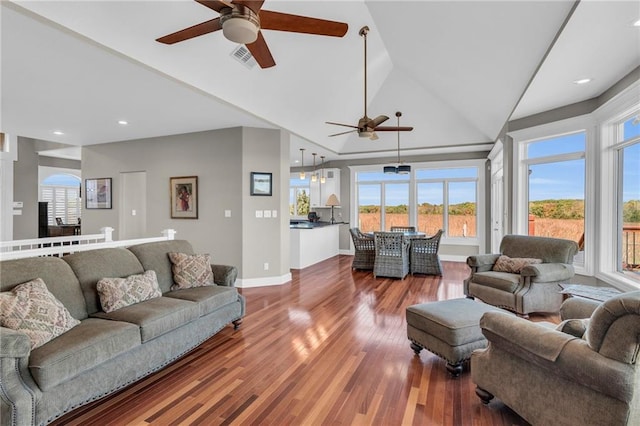 living room with lofted ceiling, wood finished floors, a ceiling fan, visible vents, and baseboards