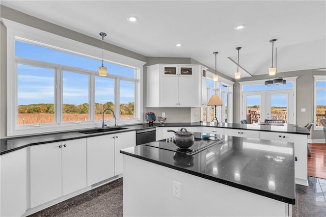 kitchen with a center island, black electric stovetop, recessed lighting, a sink, and a peninsula