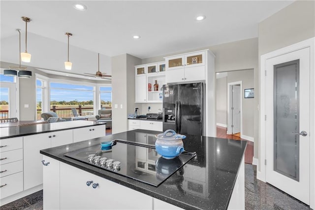 kitchen featuring recessed lighting, white cabinets, granite finish floor, and black appliances