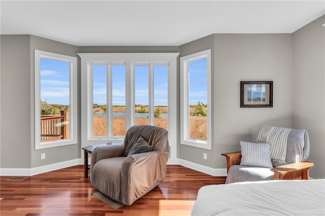 bedroom featuring baseboards and wood finished floors