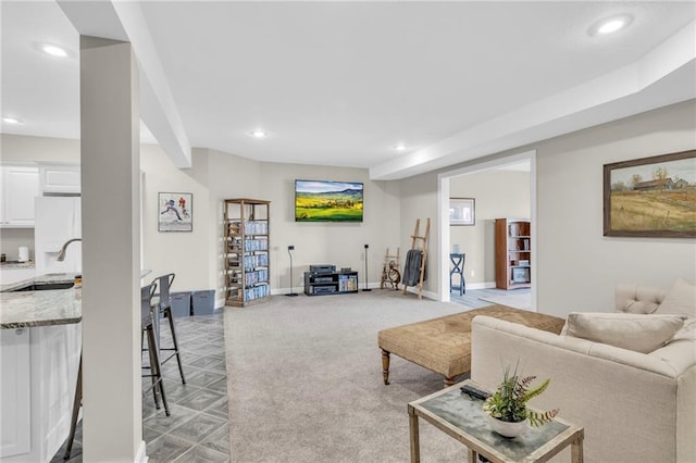 living room with recessed lighting, light colored carpet, and baseboards