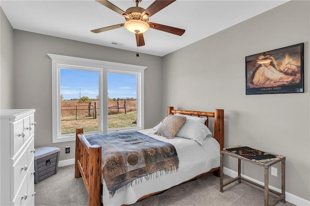 bedroom featuring a ceiling fan, carpet flooring, visible vents, and baseboards