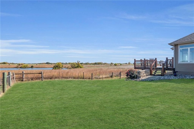 view of yard with a wooden deck and fence