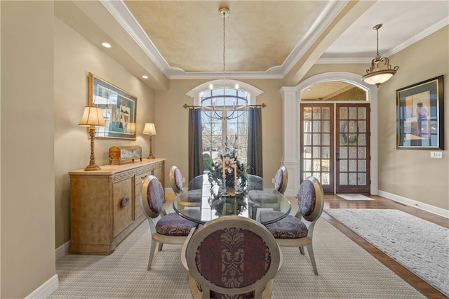 dining area with french doors, baseboards, ornamental molding, and a chandelier