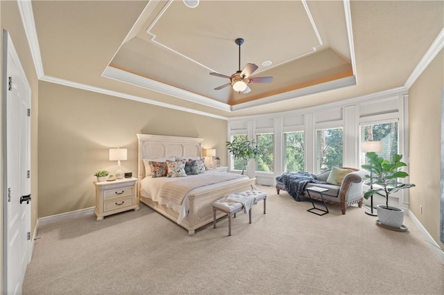 bedroom featuring a tray ceiling, ornamental molding, and light carpet