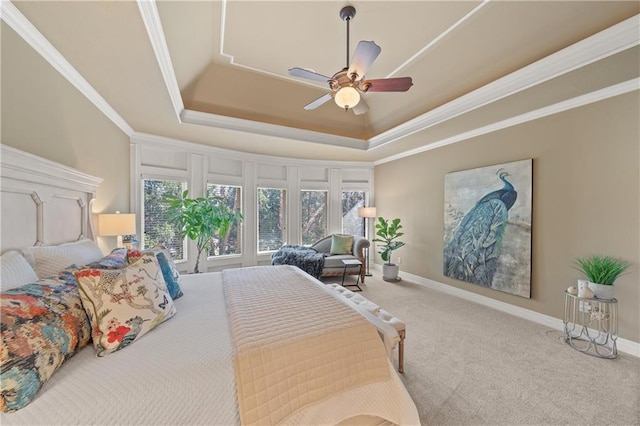 bedroom featuring baseboards, a tray ceiling, carpet, and ornamental molding