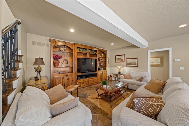 living room with stairway, recessed lighting, visible vents, and a textured ceiling