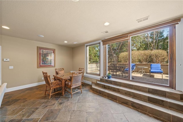 dining space featuring visible vents, recessed lighting, a textured ceiling, and baseboards