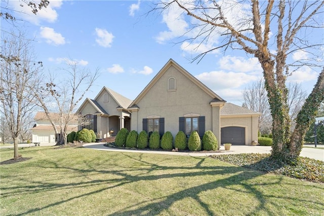 view of front of home featuring a front yard, concrete driveway, a garage, and stucco siding