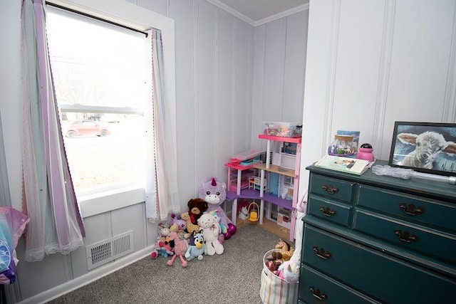 playroom with carpet floors, visible vents, ornamental molding, and a decorative wall