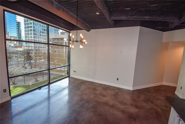 interior space featuring finished concrete flooring, baseboards, and an inviting chandelier